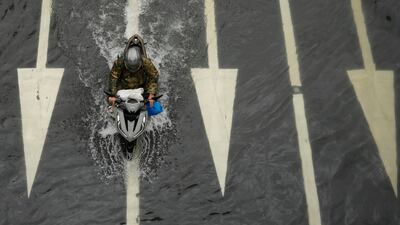 A motorcycle ploughs through a flooded road after Tropical Storm Wipha brought monsoon rains to Manila, the Philippines. AP