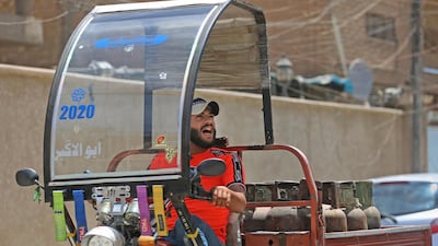 Gas cylinder delivery man Mountazar Abbas sings from his rickshaw to announce his arrival in the Karrada district of Baghdad. AFP