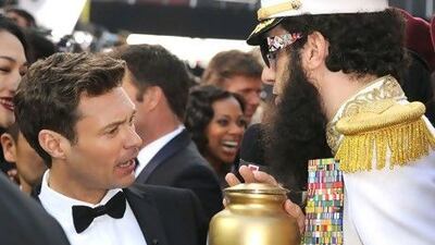 Ryan Seacrest reacts to Cohen as 'The Dictator' when he threw ashes from an urn on the TV host. Steve Granitz / Wire Image