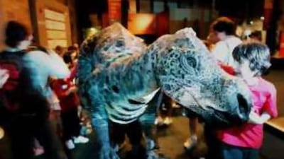Children play with a dinosaur puppet as they prepare to sleep over at the Australian Museum.