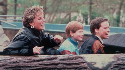 Diana on an amusement park ride with her sons Prince Harry (centre) and Prince William. PA