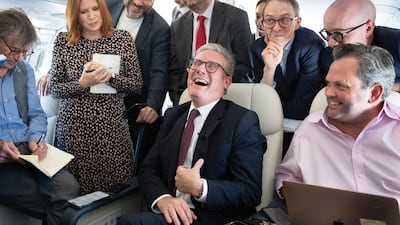 Mr Starmer talks to the media on board his plane as he flies to Washington in September 2024