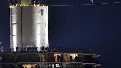 The silhouette of Nik Wallenda is cast against the West Marina tower as he begins his tightrope walk uphill at a 15-degree angle, from the Marina City west tower across the Chicago River to the top of the Leo Burnett Building. Charles Rex Arbogast/ AP Photo