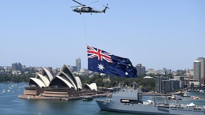 A Royal Australian Navy MH-60R Seahawk helicopter flies an Australian national flag over Sydney Harbour during Australia Day celebrations in Sydney, Australia. EPA