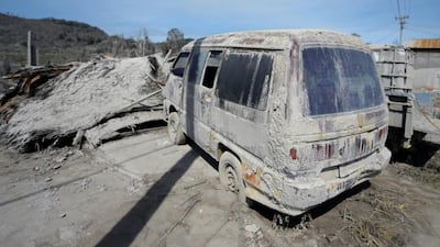 Cars are covered with volcanic ash after eruptions from Mount Sinabung in the abandoned village of Sigarang-garang on February 5, 2014. A volcano in western Indonesia that killed 15 people in a weekend eruption shot hot ash and rocks high into the air again on February 3, halting a search for any more victims. Adek Berry / AFP Photo