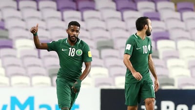 Nawaf Alabid, left, celebrates after scoring from a penalty as Saudi Arabia take a 1-0 lead at Hazza bin Zayed Stadium on Tuesday. Chris Whiteoak / The National