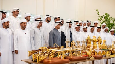President Sheikh Mohamed and Sheikh Mansour bin Zayed with the Presidential Camel Racing Team. Photo: UAE Presidential Court