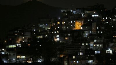 The moon is seen over a slum near Copacabana Beach in Rio. Carlos Barria / Reuters