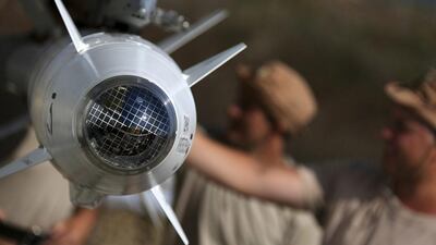 Russian military support crew inspect missiles attached to their jet at an air base in Syria. Russian Defense Ministry Press Service / AP Photo