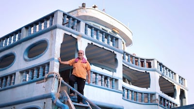 A dhow's cook oversees the loading of items. Reem Mohammed / The National