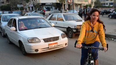 Egyptian Yasmine Mahmoud, a 31-year-old executive secretary, rides her bicycle in Cairo on December 25, 2014. Mohamed El Shahed/AFP Photo