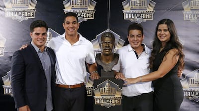 Children of former NFL player Junior Seau, from left, Tyler, Jake, Hunter, and Sydney pose for a photo with the bust of their late father during inductions at the Pro Football Hall of Fame on Saturday, Aug. 8, 2015, in Canton, Ohio. Gene J. Puskar / AP Photo