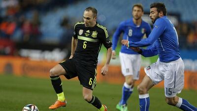 Andres Iniesta and Spain beat Italy 1-0. They'll play in Group B at the 2014 World Cup with Netherlands, Chile and Australia. Paul White / AP