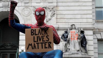 A person dressed as Spider-Man sits on a car near an area being called the "City Hall Autonomous Zone" that has been established to protest the New York Police Department and in support of "Black Lives Matter" near City Hall in lower Manhattan. Reuters
