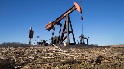 An idled pump jack sits rusting above a well on the edge of a farmers field near Ridgway, Illinois. Scott Olson / Getty Images / AFP