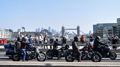 Members ride across London Bridge in March 2022. AFP