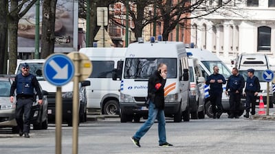 Police secure an area during a house search in the Etterbeek neighbourhood in Brussels on April 9, 2016. The arrest Friday of six men suspected of links to the Brussels bombings, including the last known fugitive in last year's Paris attacks, raised new questions about the extent of the ISIL cell believed to have carried out the intertwined attacks that left 162 people dead in two countries. Geert Vanden Wijngaert/AP Photo