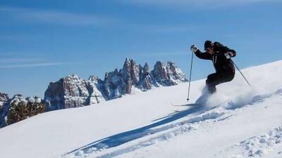 Skiing in the famous Cinque Torri in the Dolomites, northeastern Italy. EyesWideOpen / Getty Images
