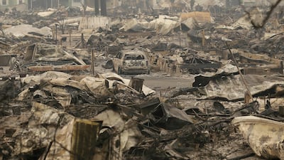 A car sits in the middle of property destroyed from fires at Journey's End mobile home park in Santa Rosa, California. Jeff Chiu / AP Photo