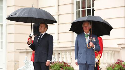 Britain's Prince Charles and French President Emmanuel Macron inspect a guard of honour from the Grenadier Guards at Clarence House in central London. AFP