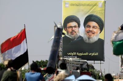 Supporters of the Houthi rebels gather in front of a billboard showing Hezbollah leaders Hassan Nasrallah, right, and Hashem Safieddine during a protest against Israel in the Yemeni capital last week. EPA