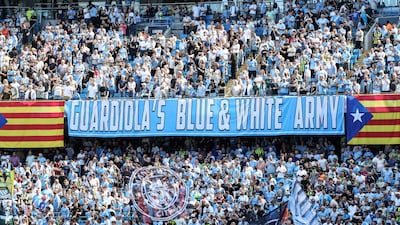 Supporters hold up banners for Manchester City's outgoing manager Pep Guardiola. AFP