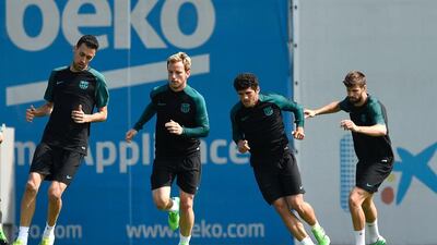 Barcelona's Sergio Busquets, Ivan Rakitic, Carles Alena Gerard Pique take part in a drill. Lluis Gene / AFP