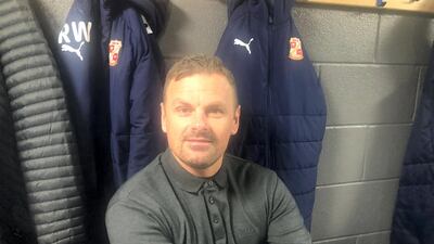 Swindon manager Rich Wellens in the changing room before the game
