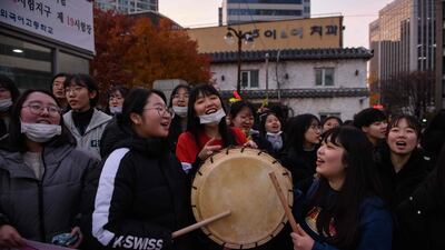 Students gather to cheer on others arriving outside the Ehwa Girls Foreign Language High School in Seoul, South Korea. AFP