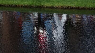 Woods acknowledges the fans while walking across the 16th hole. AFP