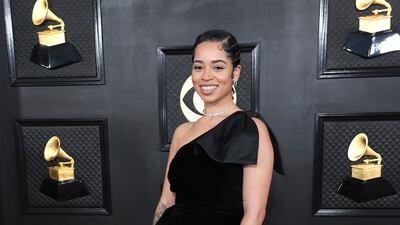 Ella Mai arrives in a black one-shoulder gown. AP