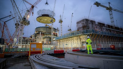 The world's largest crane, Big Carl, lifts a 245-tonne steel dome on to Hinkley Point C's first reactor building in Somerset, as Britain looks to step up its nuclear output. PA