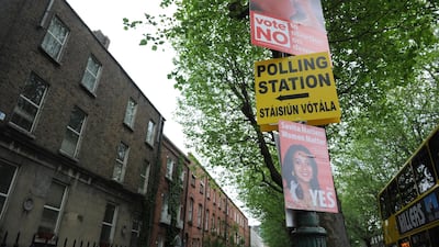 Campaign posters are fixed beside a sign for a polling station in Dublin, Ireland. Aidan Crawley/ EPA