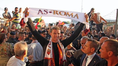 Edin Dzeko arrives at Rome Fiumicino airport to undergo a medical ahead of a move to AS Roma. Telenews / EPA