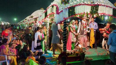Indian brides and grooms seen during a mass wedding of 111 fatherless women in Surat, some 265 kms from Ahmedabad, on November 30, 2014. An Indian diamond trader Mahesh Savani paid for their weddings. AFP Photo
