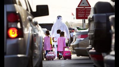 Students arrive to the Al Sanawbar School on the first day of the third term along Khalid bin Sultan street in Al Ain. Christopher Pike / The National
