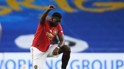 Paul Pogba takes a knee in support of the Black Lives Matter campaign before the match. Reuters