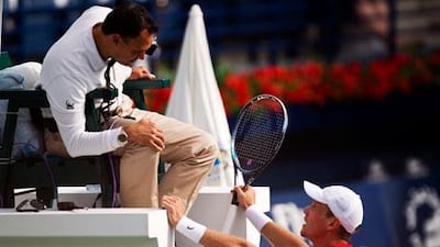 Tomas Berdych, right, has an argument with the chair umpire in Dubai on Thursday.