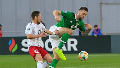 Ireland's Shane Duffy, right, fights for the ball with Jano Ananidze of Georgia. AP