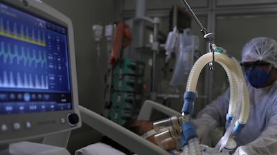 A health worker treats a Covid-19 patient at the Intensive Care Unit of Hospital Sao Paulo in Sao Paulo, Brazil. Reuters