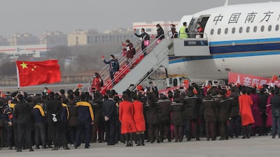 Airport staff members welcome members of a medical assistance team from Shenyang upon their return home after helping with the COVID-19 coronavirus recovery effort in Wuhan, in Shenyang in China's northeastern Liaoning province. AFP