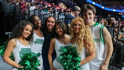Performers pose for photos courtside during the game. Victor Besa / The National
