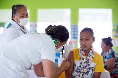 A girl receives a vaccine during a nationwide campaign against measles in Samoa. Allan Stephen / AFP
