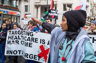 A nurse and healthcare workers at a large pro-Palestinian protest in London against the Israeli military targeting hospitals in Gaza. Getty Images