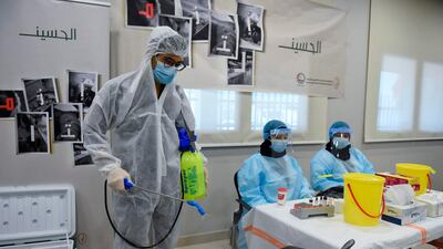 A volunteer disinfects a chair as medics prepare to receive Muslim Shiite mourners to give blood on the 9th of the Muslim month of Muharram as part of Ashura commemorations, in Alnoaim village, a suburb of the Bahraini capital Manama. AFP