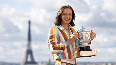 Iga Swiatek of Poland poses with her trophy on the rooftop of the Galerie Lafayette department store with the Eiffel Tower in the background a day after beating Sofia Kenin in the women's final. EPA