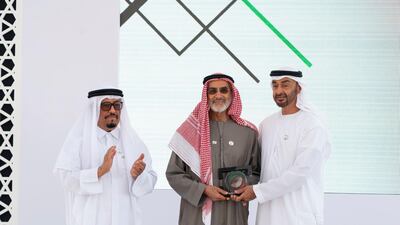 Sheikh Mohamed bin Zayed presents an award for founder and chairman of the family council Ali bin Khalfan AL Dhaheri (centre), on behalf of Ali & Sons Holding for participating in Sandooq Al Watan, during a Sea Palace barza. They are seen with Lt General Dhahi Khalfan Tamim, Chairman of the Board of Directors at Sandooq Al Watan. Rashed Al Mansoori / Ministry of Presidential Affairs