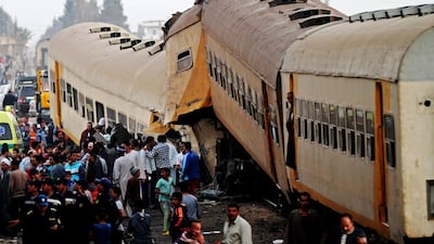 People inspect the wreckage of a passenger train that collided with a freight train in the village of Kom Hamada in the northern province of Beheira. Stringer / EPA