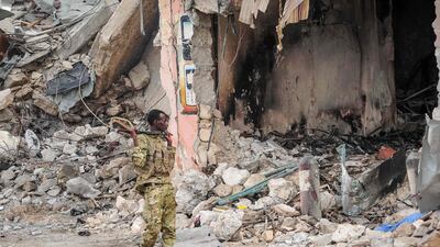 A Somali soldier patrols the scene. Mohamed Abdiwahab / AFP Photo