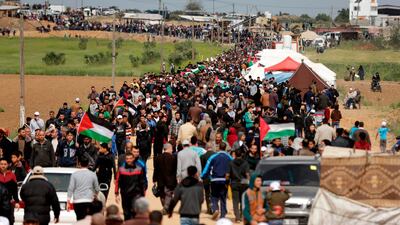 Thousands of people gathered along the Israel-Gaza Strip border where Palestinians have set up tents and were staging a march on March 30, 2018. Mahmud Hams / AFP